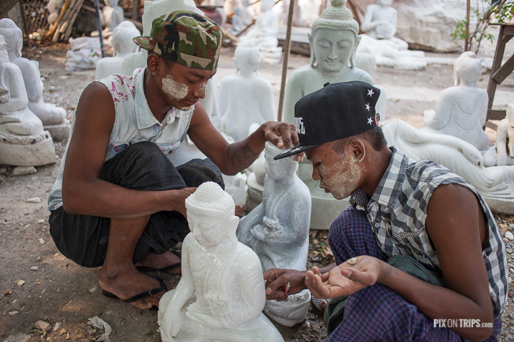 Boys carve Buddha statues in Mandalay, Myanmar