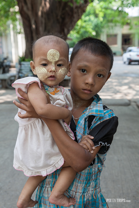 Boy holds his sister in Mandalay, Myanmar