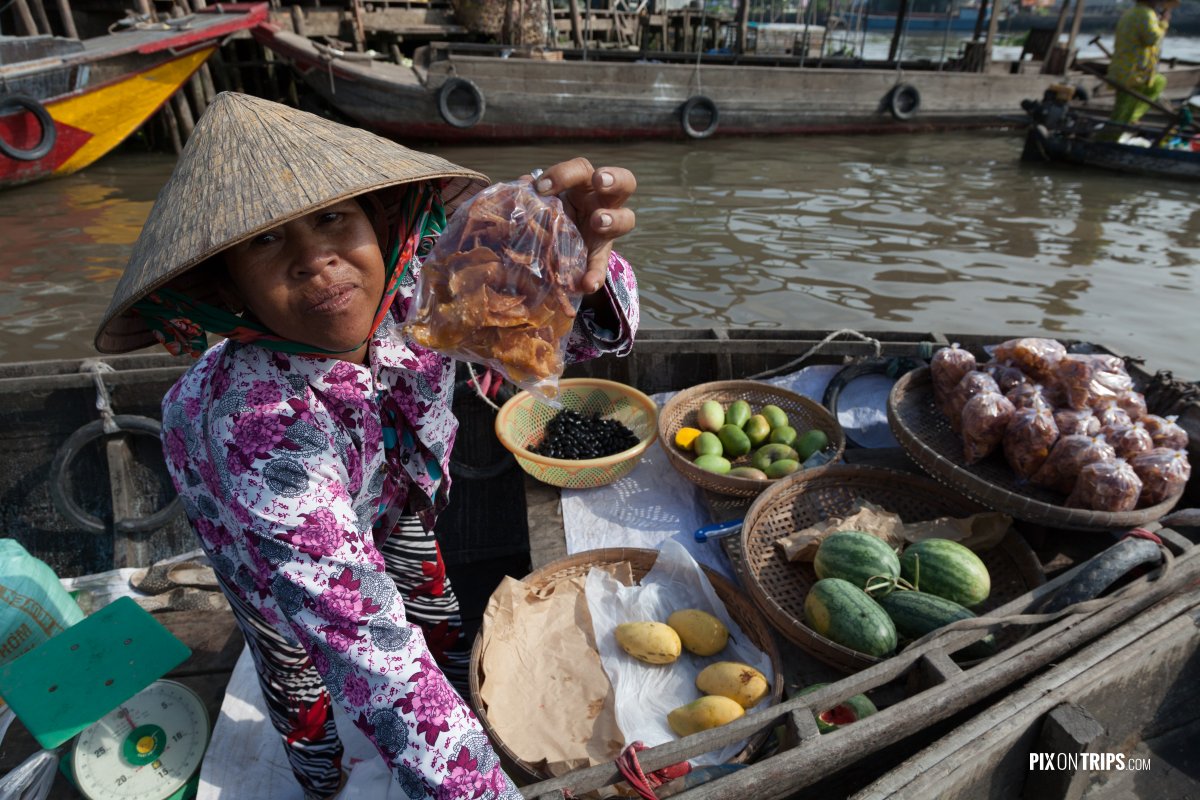 Vendor at Cai Be floating market, Vietnam - Pix on Trips