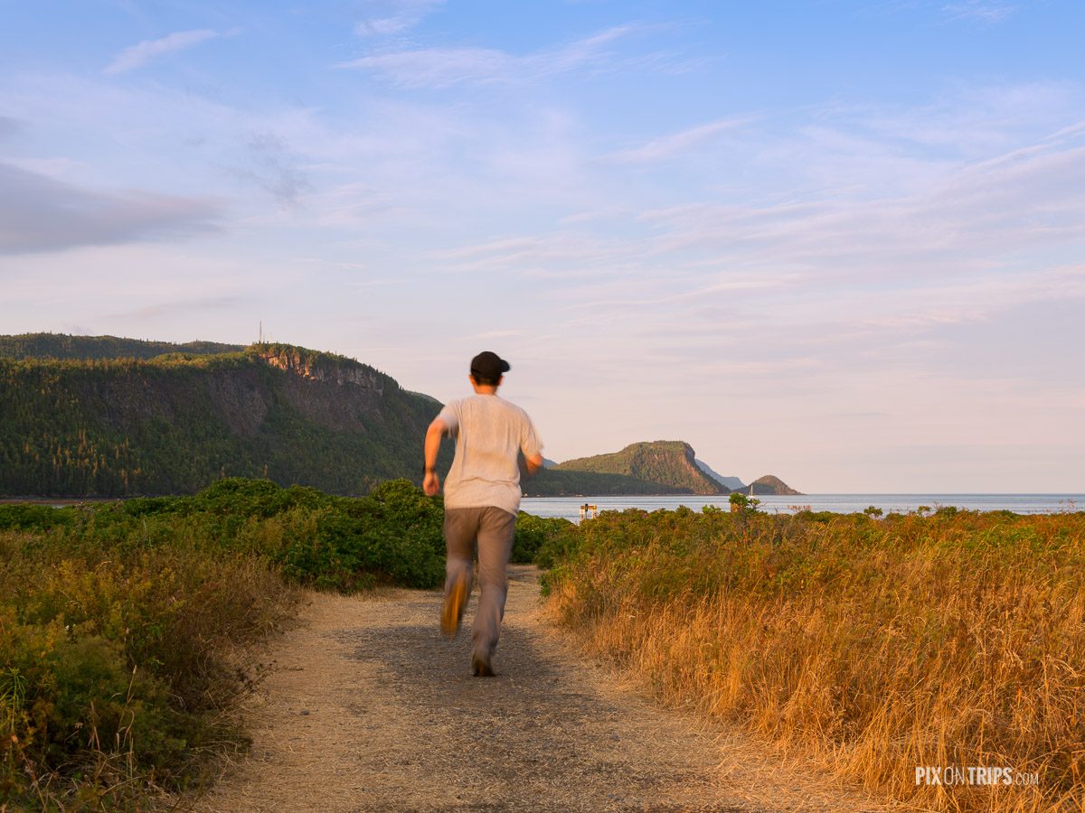 Man running along a trail leading to Bay Ha Ha in Parc National du Bic Quebec