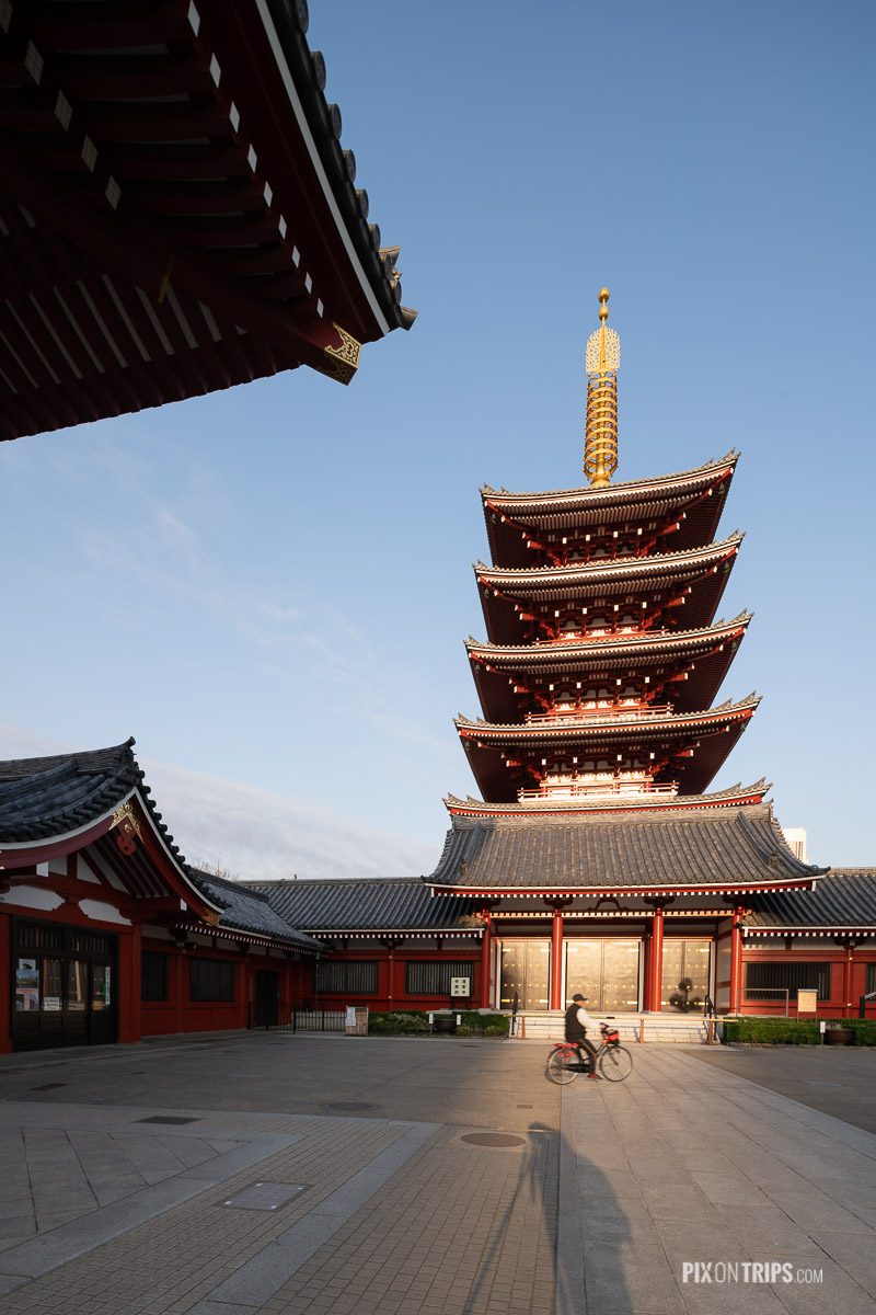 Man riding a bicycle passing by the Five-Story Pagoda at Sensoj - Pix on Trips